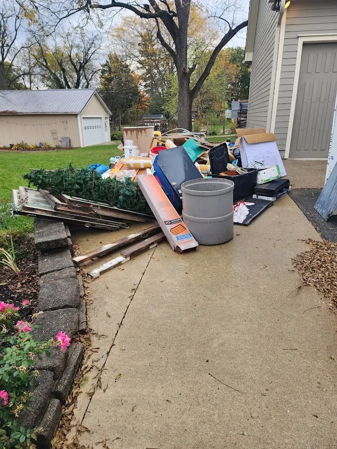 Dumpster being loaded with debris for 12 Yard Dumpster Rental in Elkhorn